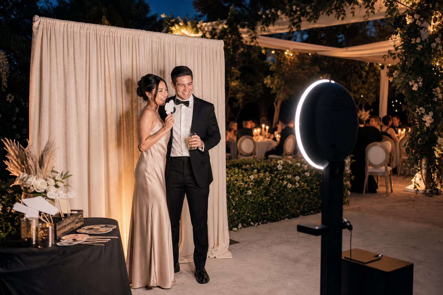 Guests enjoying an elegant open-air photo booth at a wedding reception